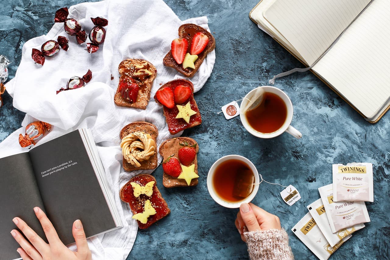 Tea and small pastries spread on a table
